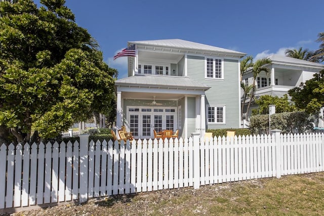 view of front facade with a fenced front yard and metal roof