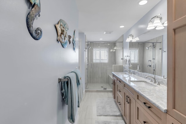 bathroom with an enclosed shower, vanity, and tile patterned floors