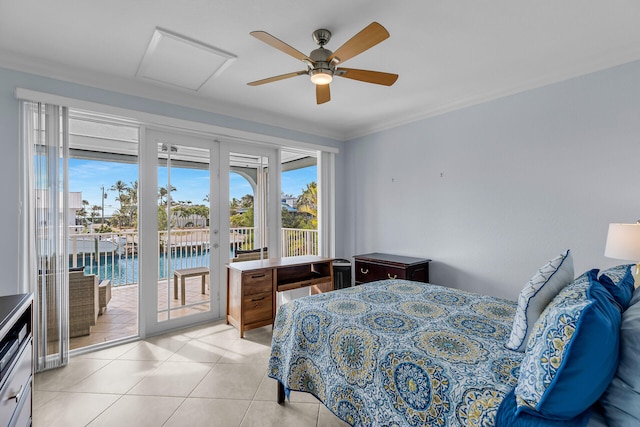 bedroom featuring ornamental molding, light tile patterned floors, access to exterior, ceiling fan, and a water view