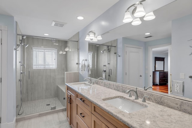 bathroom featuring vanity and a shower with shower door