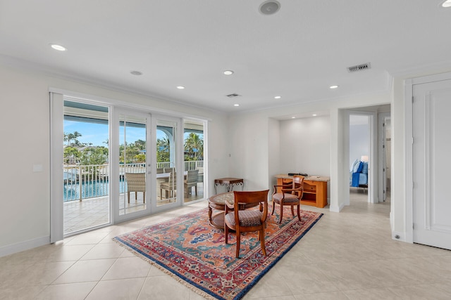 tiled dining area with ornamental molding and french doors