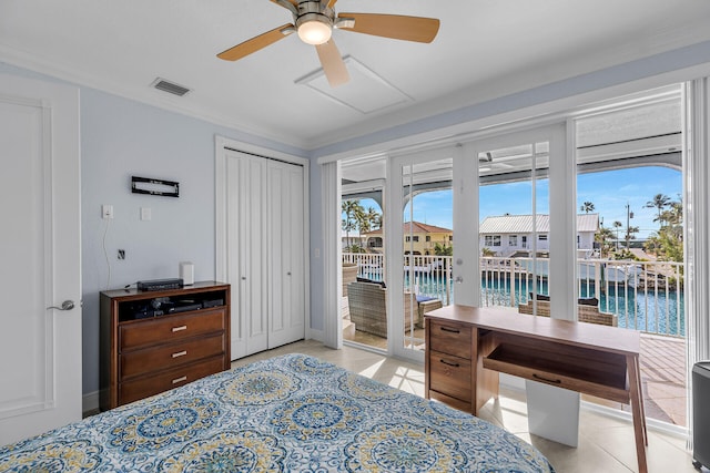 bedroom featuring a water view, access to exterior, multiple windows, and light tile patterned floors