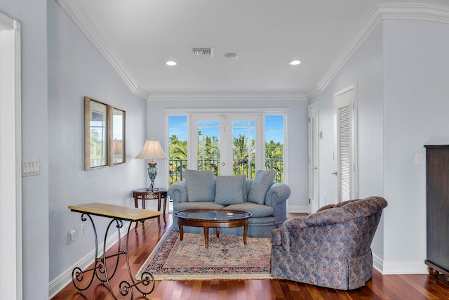 living room featuring dark wood-type flooring, ornamental molding, and french doors