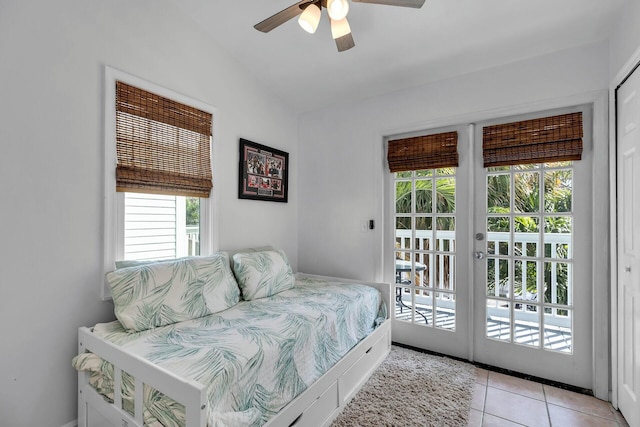bedroom with access to exterior, light tile patterned floors, ceiling fan, and vaulted ceiling