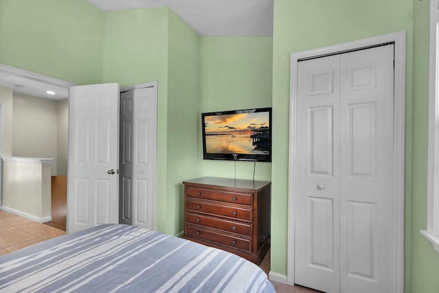 bedroom with light tile patterned floors and baseboards