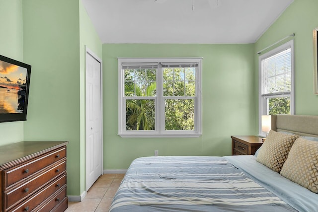 bedroom with a closet, baseboards, and light tile patterned flooring