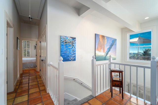 hall featuring beam ceiling and tile patterned flooring