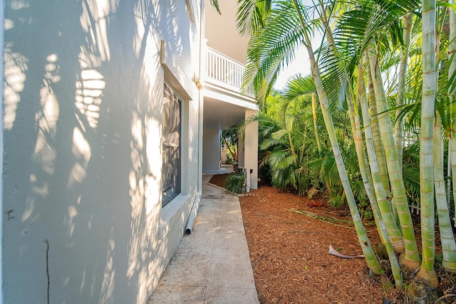 view of side of home with a balcony