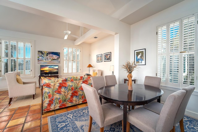 tiled dining space with ceiling fan and beam ceiling