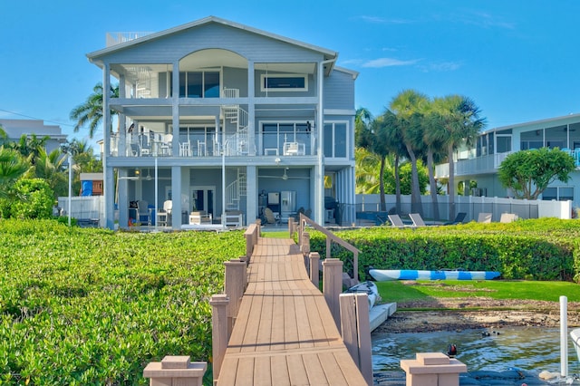 back of house featuring a water view and a balcony