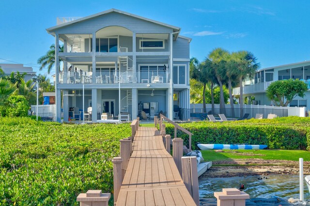 back of house featuring a water view and a balcony