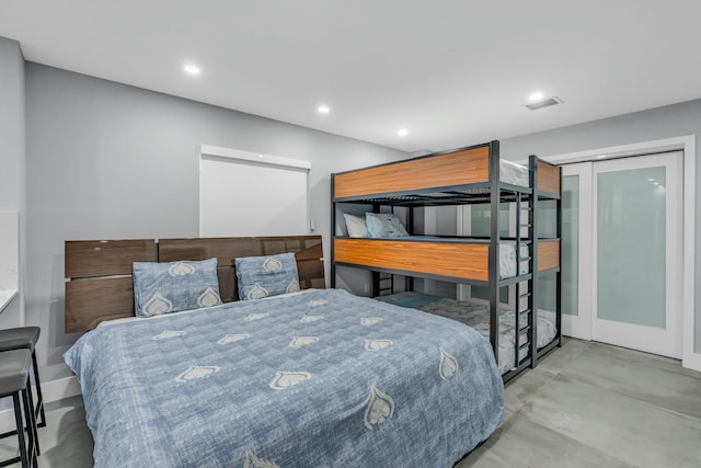 bedroom featuring concrete flooring