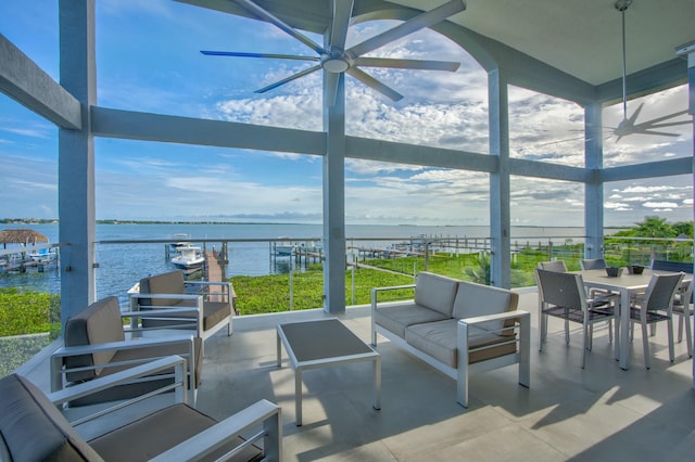 view of patio / terrace with a water view, ceiling fan, and outdoor lounge area