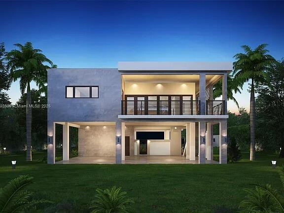 back house at dusk featuring a patio, a balcony, and a lawn