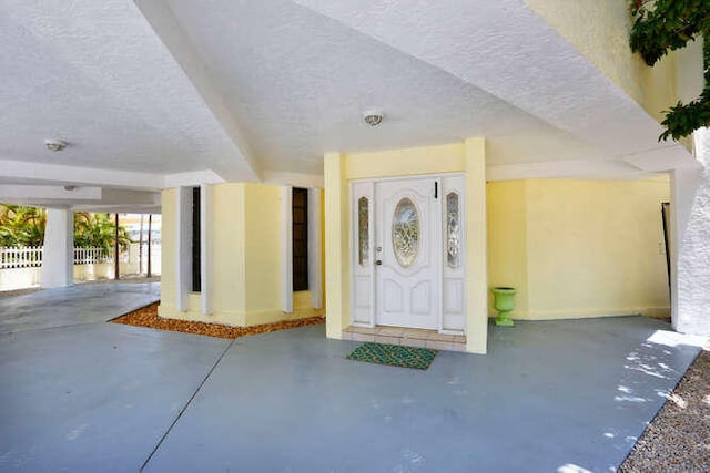 doorway to property featuring fence