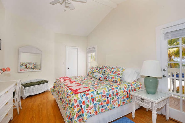 bedroom featuring ceiling fan, vaulted ceiling, and wood finished floors