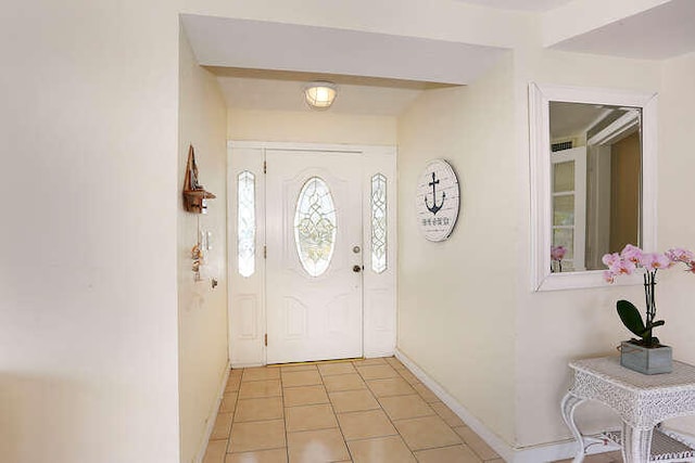 entrance foyer with baseboards and light tile patterned floors