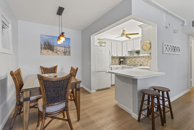 1101 W Ocean Dr Unit 29, Key Colony, FL 33051 - dining room featuring light wood-type flooring and a ceiling fan