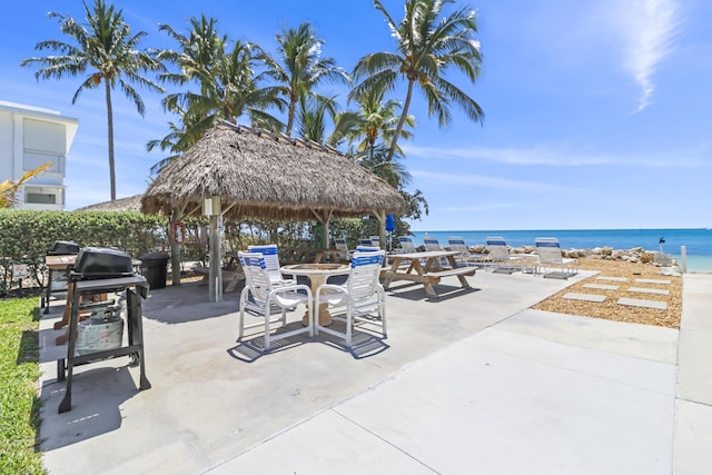 1101 W Ocean Dr Unit 29, Key Colony, FL 33051 - view of patio / terrace featuring a gazebo, a water view, area for grilling, and outdoor dining area