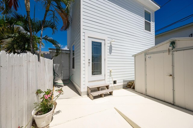 1205 11th St, Key West, FL 33040 - exterior space with crawl space, fence, an outbuilding, a patio, and a storage unit