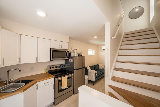 1205 11th St, Key West, FL 33040 - kitchen featuring wood counters, a sink, white cabinets, and stainless steel appliances