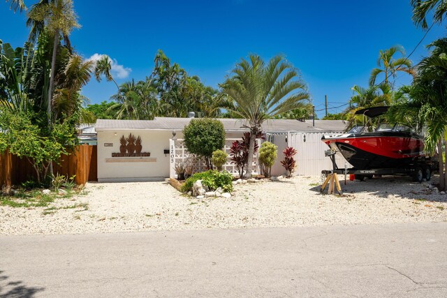 1205 11th St, Key West, FL 33040 - view of front of property featuring stucco siding and fence