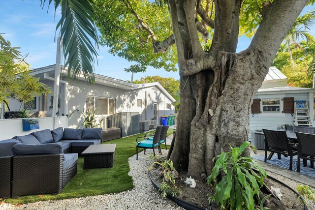 view of yard featuring cooling unit, a patio area, outdoor lounge area, and fence