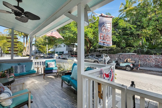 wooden deck with ceiling fan and a porch