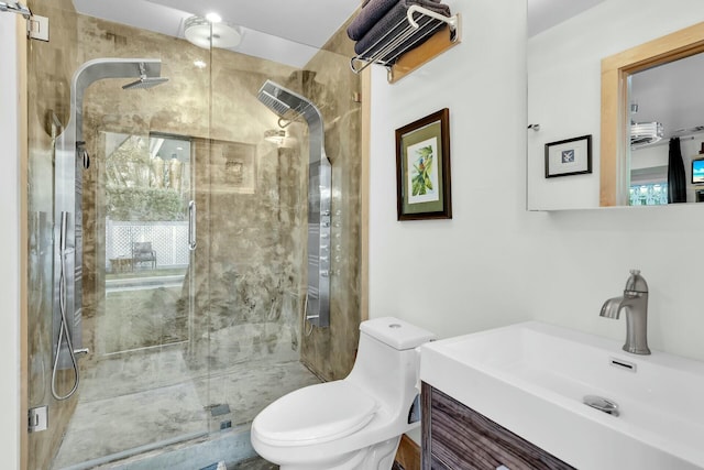 full bathroom with vanity, toilet, and a shower stall