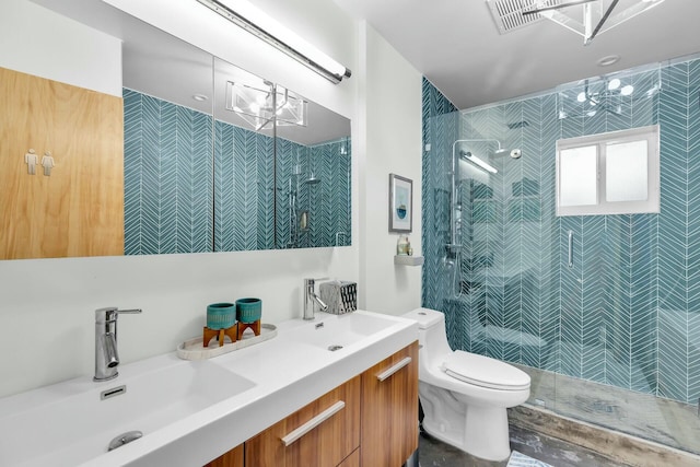 full bath with tiled shower, a sink, toilet, and double vanity