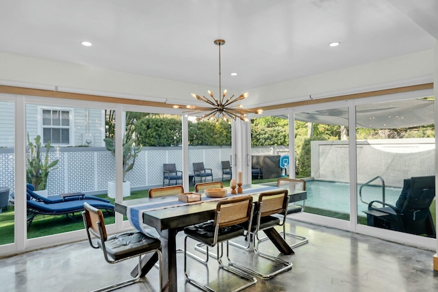 sunroom / solarium with a notable chandelier