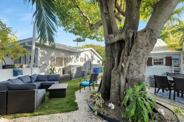 view of yard with central air condition unit, outdoor lounge area, a patio, and fence