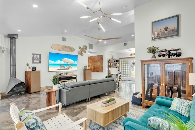 living room with lofted ceiling, a wood stove, and visible vents