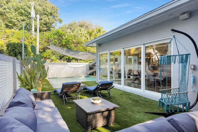 exterior space featuring a fenced backyard, outdoor lounge area, and a fenced in pool