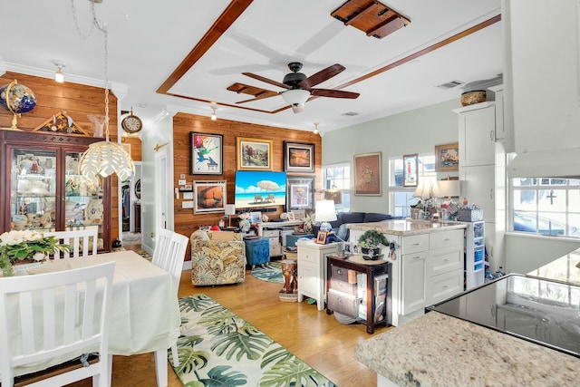 kitchen with visible vents, light wood-style flooring, open floor plan, white cabinets, and light stone countertops