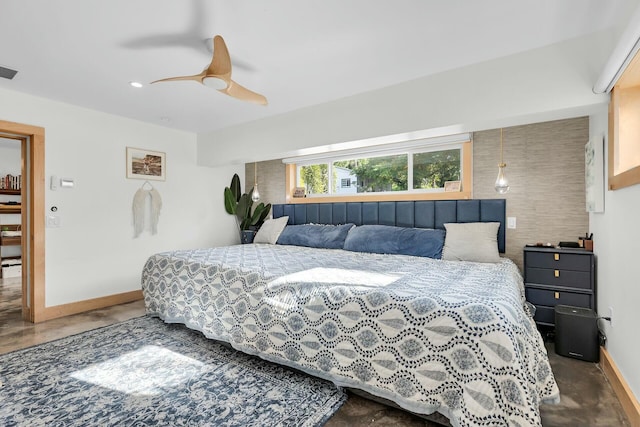 bedroom featuring visible vents, finished concrete floors, baseboards, and a ceiling fan