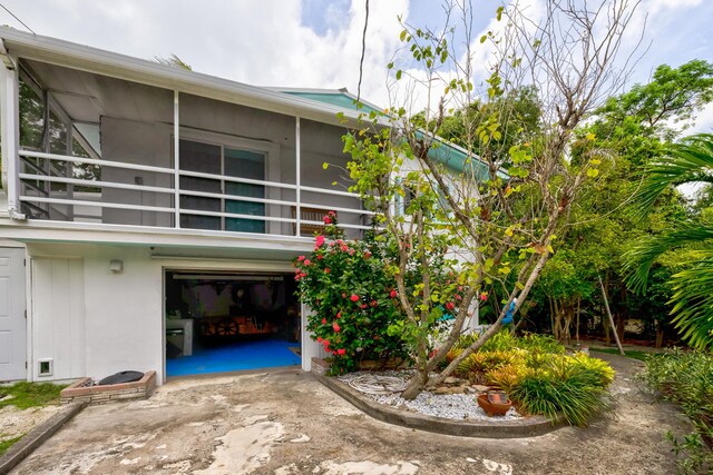 back of house with a balcony and a garage