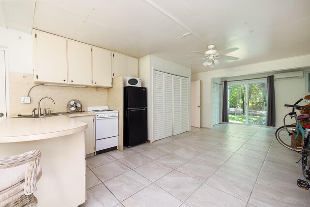 kitchen featuring sink, white appliances, ceiling fan, white cabinets, and light tile patterned flooring