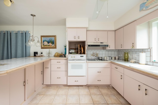 kitchen featuring white oven, tasteful backsplash, white cabinets, decorative light fixtures, and kitchen peninsula