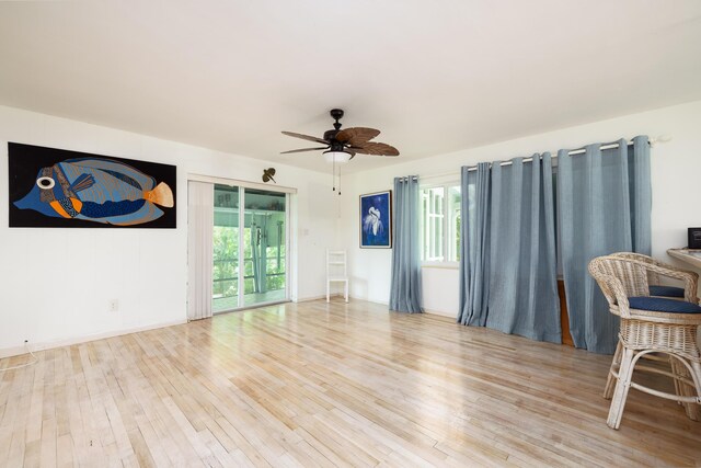 living room featuring ceiling fan and light hardwood / wood-style flooring