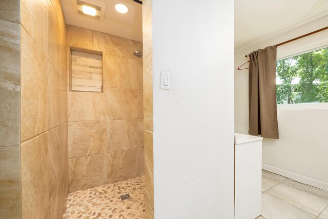 bathroom with tile patterned floors and a tile shower