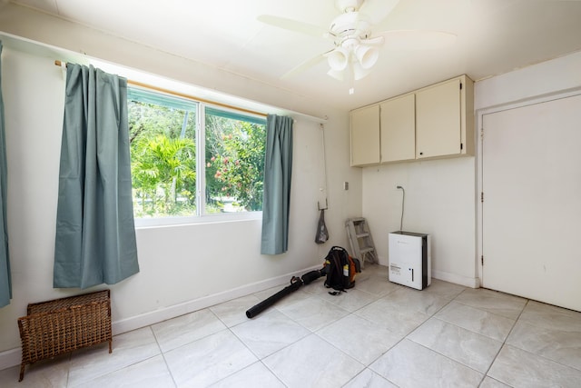 washroom with ceiling fan and light tile patterned flooring