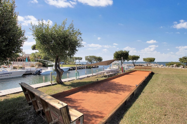 dock area featuring a water view and a lawn