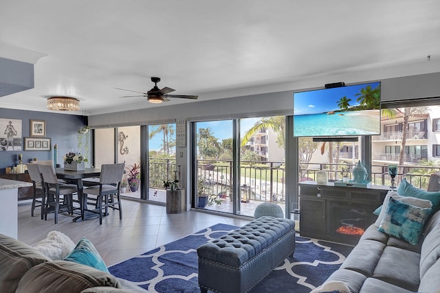 living room with tile patterned flooring, ceiling fan, and a fireplace