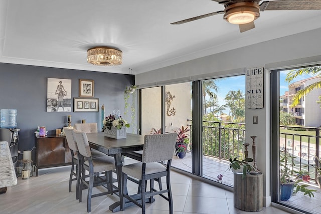 tiled dining room with crown molding and ceiling fan