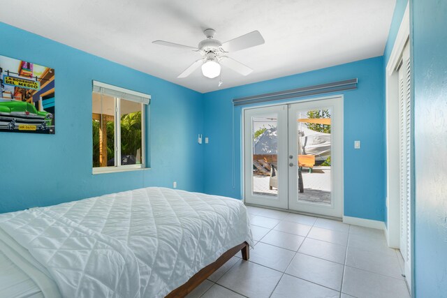 bedroom featuring access to exterior, tile patterned floors, multiple windows, and french doors