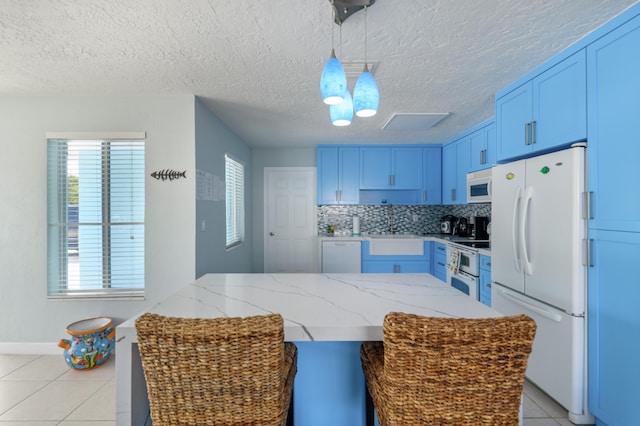 kitchen featuring white appliances, tasteful backsplash, light tile patterned floors, and blue cabinetry