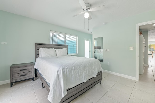 bedroom with multiple windows, baseboards, and light tile patterned floors