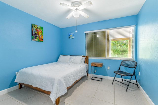 bedroom with ceiling fan, tile patterned floors, and baseboards