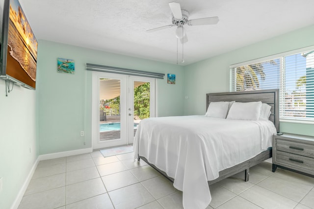 bedroom with access to outside, french doors, multiple windows, and light tile patterned flooring